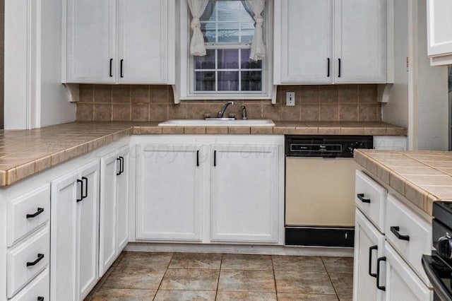 3704 Fountain Ter, Amarillo, TX 79106 - kitchen featuring white dishwasher, tile countertops, a sink, and white cabinets
