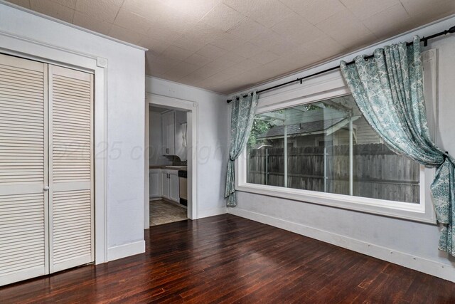 3704 Fountain Ter, Amarillo, TX 79106 - unfurnished bedroom featuring wood-type flooring, baseboards, crown molding, and a closet