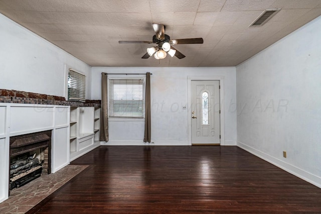 3704 Fountain Ter, Amarillo, TX 79106 - unfurnished living room featuring a ceiling fan, dark wood-style flooring, a fireplace with flush hearth, and baseboards