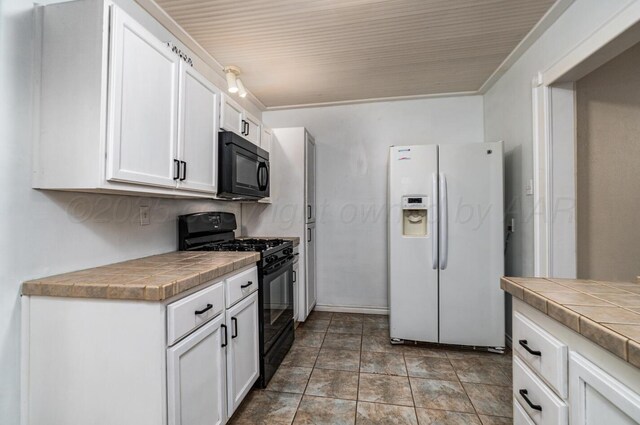 3704 Fountain Ter, Amarillo, TX 79106 - kitchen featuring black appliances, tile countertops, and white cabinetry