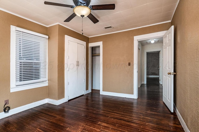 3704 Fountain Ter, Amarillo, TX 79106 - unfurnished bedroom with ornamental molding, a textured wall, dark wood-style floors, baseboards, and a closet