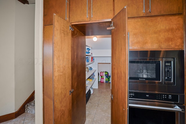 13 Prestwick Ln, Amarillo, TX 79124 - kitchen featuring stainless steel appliances, light tile patterned floors, and brown cabinets