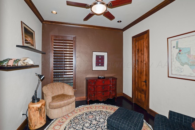 living area featuring ceiling fan and crown molding