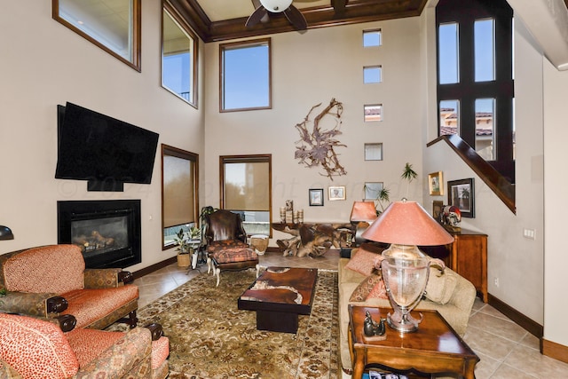 living room featuring light tile patterned floors, a towering ceiling, and ceiling fan