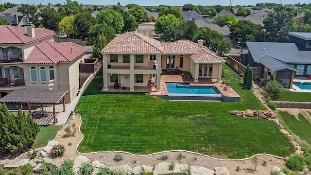 view of pool featuring a lawn and a patio area