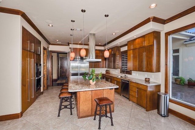 kitchen with a breakfast bar, stainless steel appliances, sink, pendant lighting, and a kitchen island
