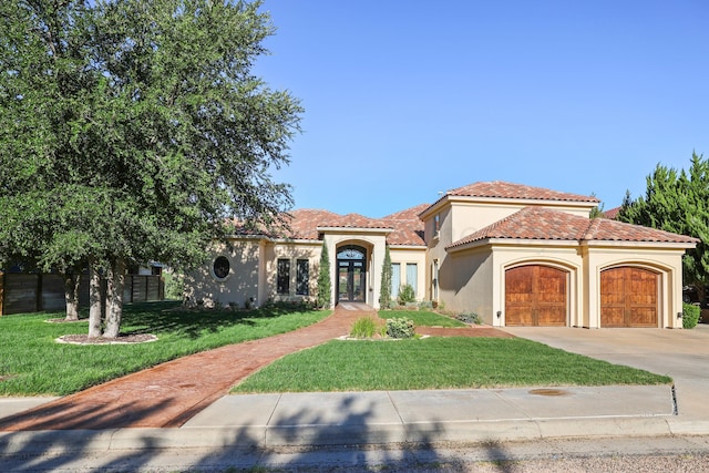 13 Prestwick Ln, Amarillo, TX 79124 - mediterranean / spanish-style house featuring stucco siding, concrete driveway, an attached garage, a tile roof, and french doors