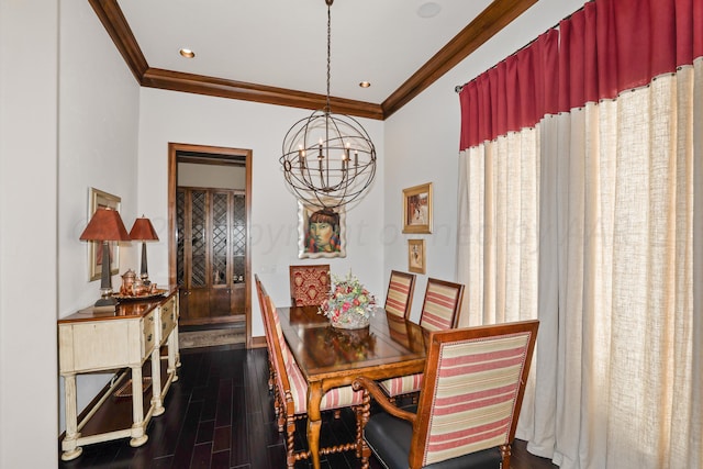 dining room featuring dark hardwood / wood-style floors, an inviting chandelier, and ornamental molding