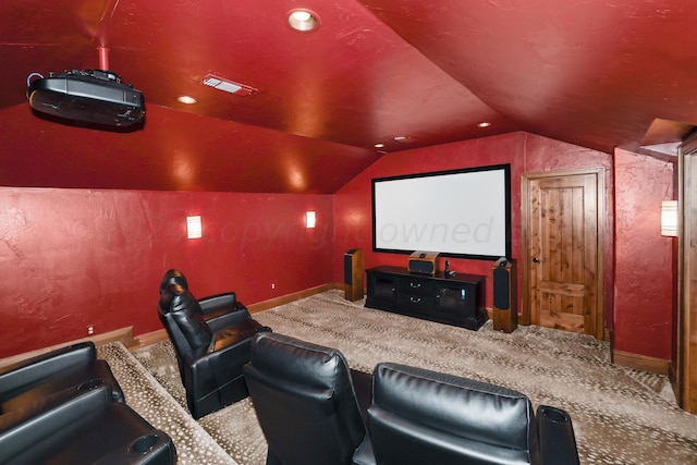 home theater featuring lofted ceiling and carpet floors