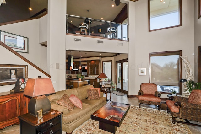 tiled living room with plenty of natural light and a high ceiling
