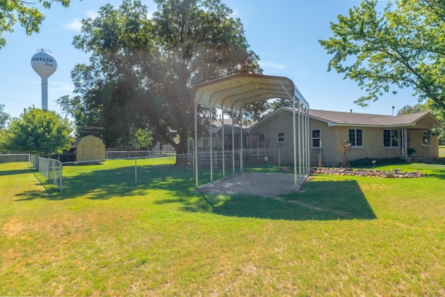 view of yard featuring a carport and a storage unit