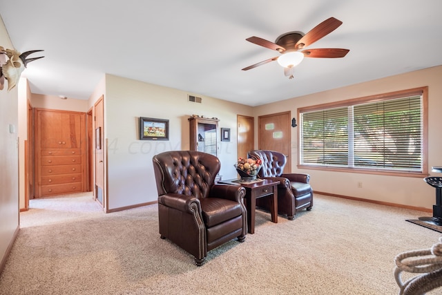 interior space featuring light colored carpet and ceiling fan