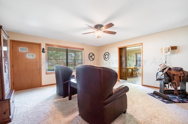 carpeted living room featuring ceiling fan