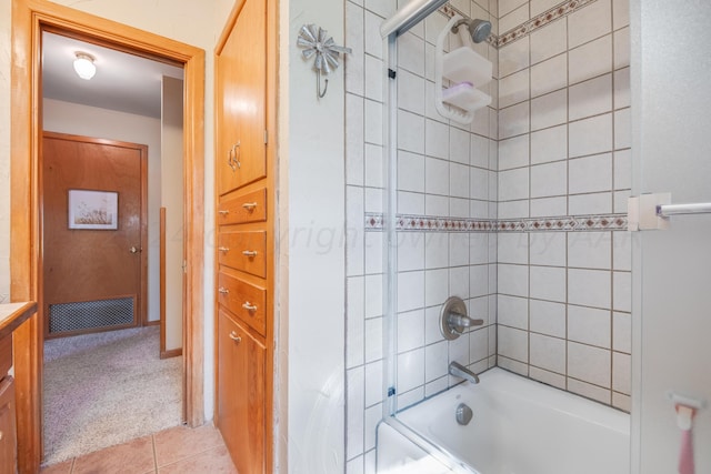 bathroom featuring tile patterned flooring, vanity, and tiled shower / bath combo