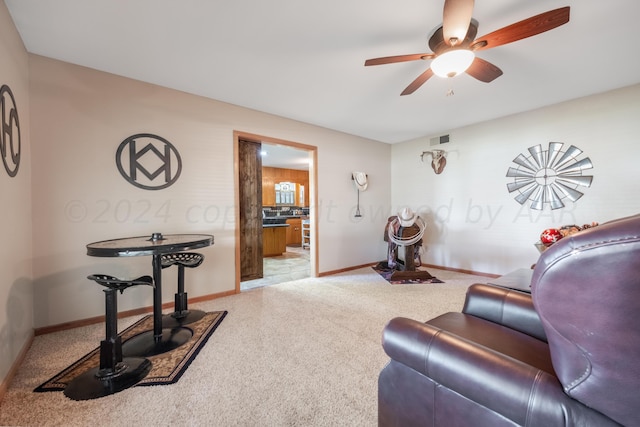 carpeted living room featuring ceiling fan