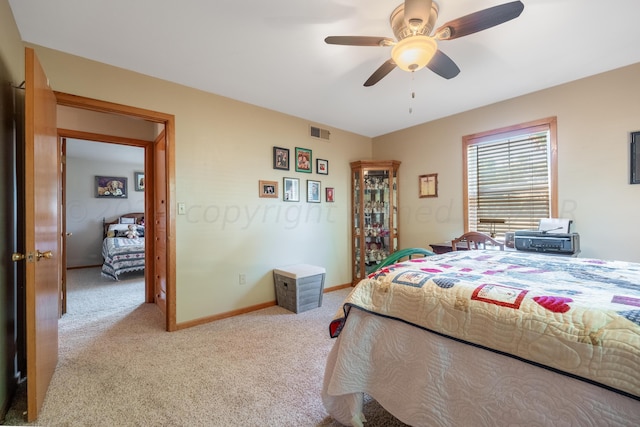 bedroom featuring light carpet and ceiling fan