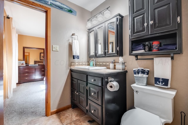 bathroom with vanity, tile patterned flooring, and toilet