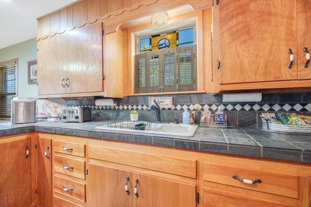 kitchen featuring sink and decorative backsplash