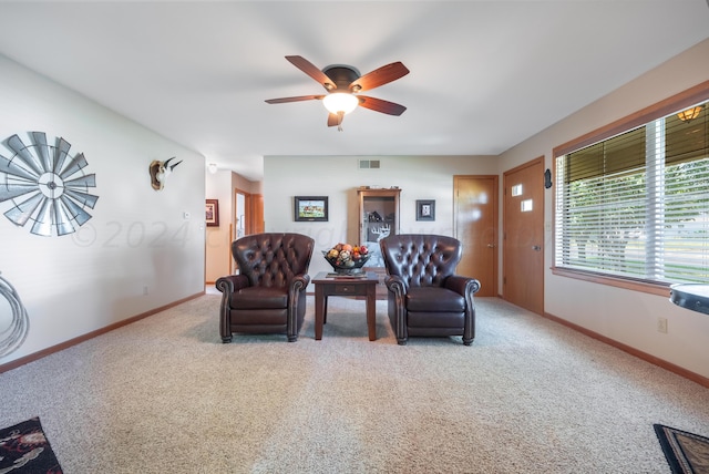 living room with ceiling fan and carpet floors