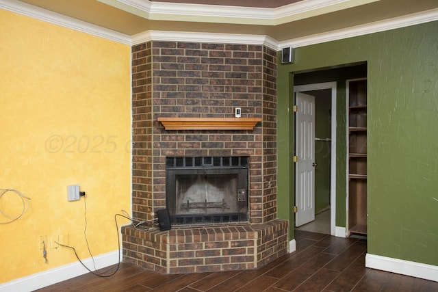 unfurnished living room featuring dark hardwood / wood-style flooring, a brick fireplace, and crown molding