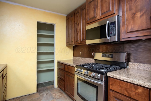 kitchen featuring stainless steel appliances and backsplash