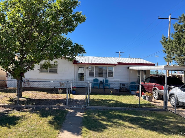 view of front of property with a front yard and a carport