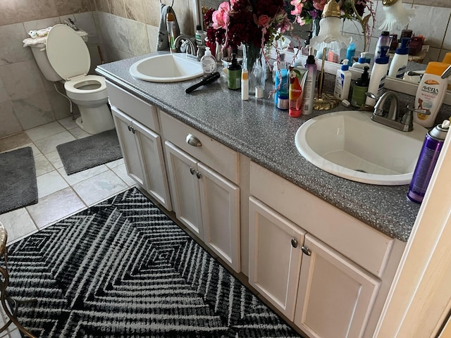 bathroom featuring tile walls, tile patterned flooring, vanity, and toilet