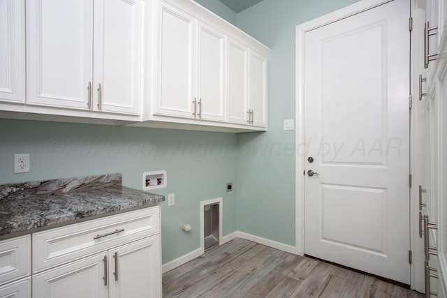 clothes washing area with baseboards, light wood-style floors, washer hookup, cabinet space, and electric dryer hookup