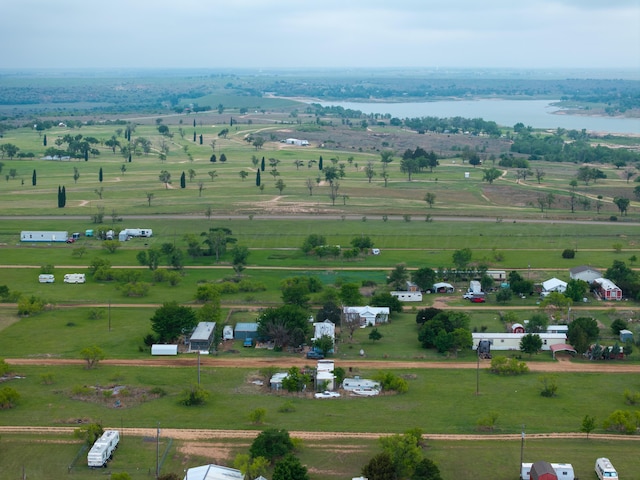 birds eye view of property with a water view and a rural view