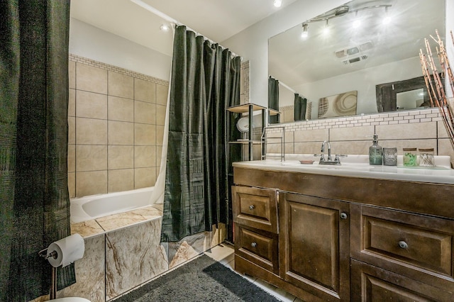 131 S Nelson St, Pampa, TX 79065 - full bathroom featuring vanity, tiled shower / bath, decorative backsplash, and tile walls