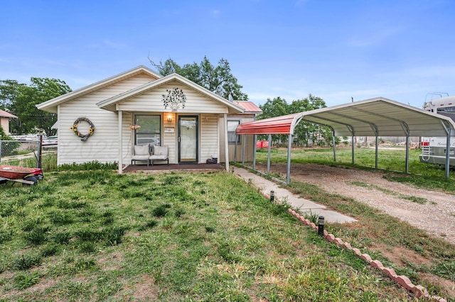 131 S Nelson St, Pampa, TX 79065 - view of front of property with a detached carport, driveway, and a porch