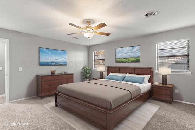 unfurnished living room with ornamental molding, light wood-type flooring, a fireplace, and ceiling fan