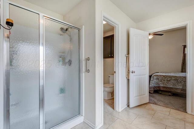 7404 Sinclair St, Amarillo, TX 79119 - ensuite bathroom featuring a stall shower, toilet, tile patterned flooring, and ceiling fan