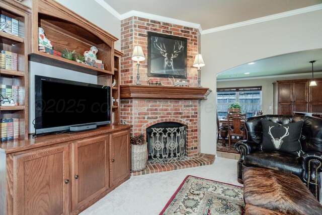 3507 Spokane Ave, Amarillo, TX 79118 - carpeted living area with ornamental molding, a fireplace, and arched walkways