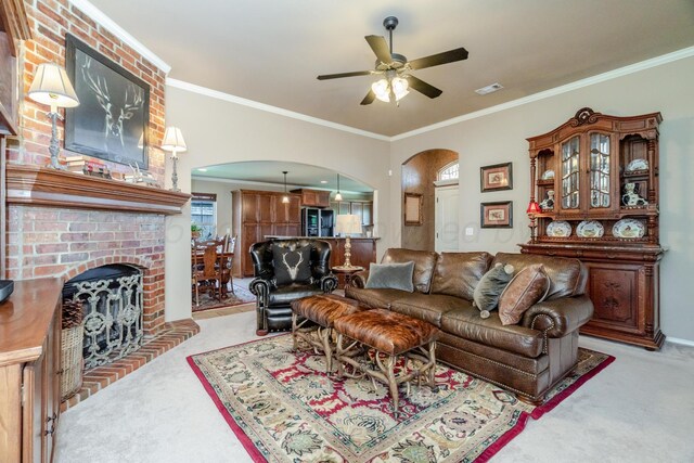 3507 Spokane Ave, Amarillo, TX 79118 - living room featuring arched walkways, light carpet, a ceiling fan, and ornamental molding