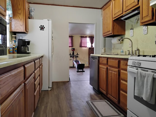 1029 S Farley St, Pampa, TX 79065 - kitchen with a sink, brown cabinetry, white appliances, dark wood-style flooring, and light countertops