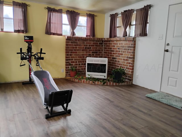 1029 S Farley St, Pampa, TX 79065 - living area with a brick fireplace, heating unit, and wood finished floors