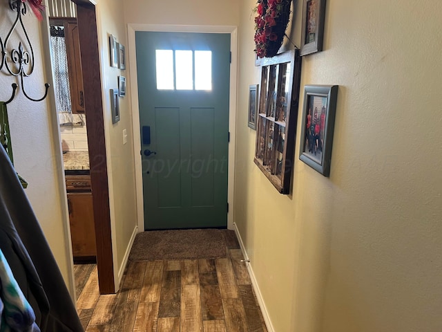 doorway to outside with wood-type flooring