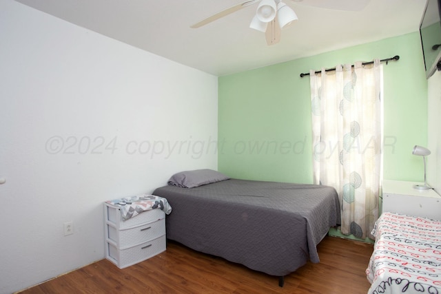 bedroom featuring ceiling fan and wood finished floors