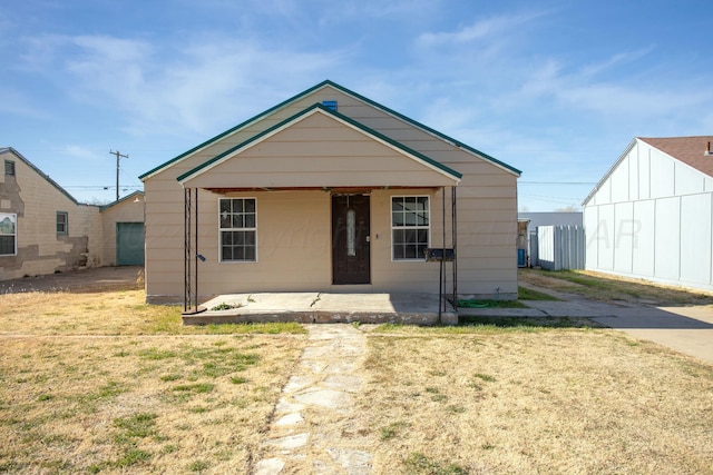 bungalow-style home with a porch and a front lawn