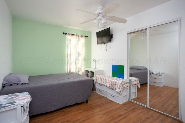 bedroom featuring a closet, a ceiling fan, and wood finished floors