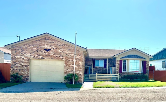 103 Frontera St, Borger, TX 79007 - ranch-style house featuring a fenced front yard, brick siding, a garage, and concrete driveway