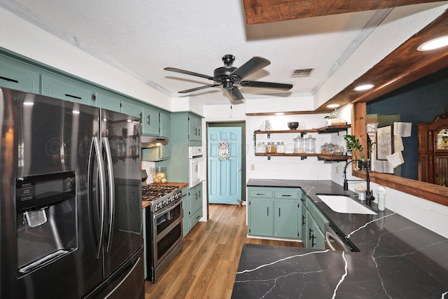 315 Walnut Ave, Panhandle, TX 79068 - kitchen featuring stainless steel appliances, green cabinetry, a ceiling fan, open shelves, and under cabinet range hood