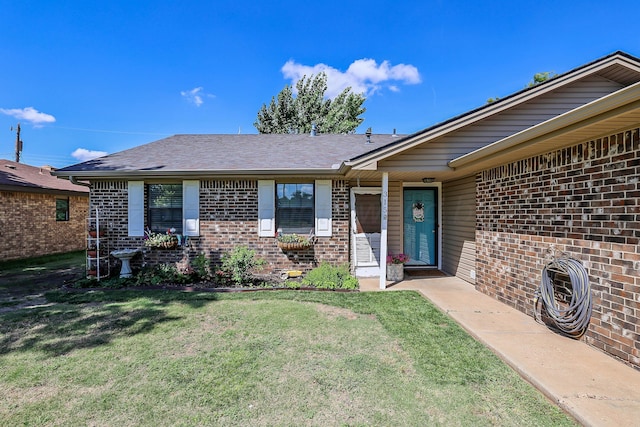 315 Walnut Ave, Panhandle, TX 79068 - doorway to property with brick siding, a lawn, and a shingled roof