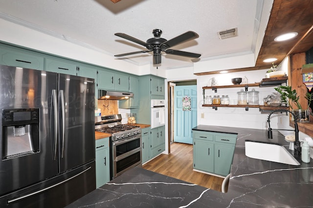 315 Walnut Ave, Panhandle, TX 79068 - kitchen featuring stainless steel appliances, open shelves, green cabinetry, under cabinet range hood, and ornamental molding