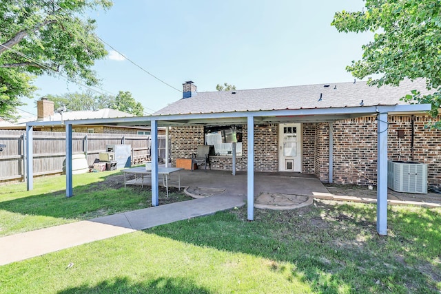 315 Walnut Ave, Panhandle, TX 79068 - rear view of house with brick siding and a patio