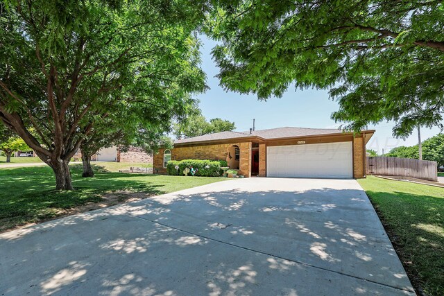 6728 Arroyo Dr, Amarillo, TX 79108 - view of front of house with an attached garage, concrete driveway, and brick siding