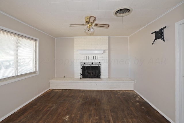 1307 Cooley Dr, Borger, TX 79007 - unfurnished living room featuring wood-type flooring, crown molding, a fireplace, ceiling fan, and baseboards
