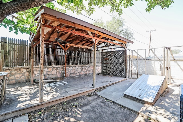 1307 Cooley Dr, Borger, TX 79007 - wooden deck featuring a ceiling fan and a fenced backyard