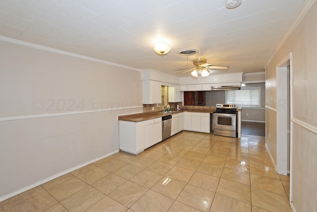 1307 Cooley Dr, Borger, TX 79007 - kitchen with appliances with stainless steel finishes, a sink, white cabinetry, ceiling fan, and light tile patterned flooring